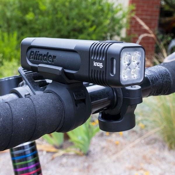 Knog Blinder 900 compact rechargeable front light on bicycle handlebars.