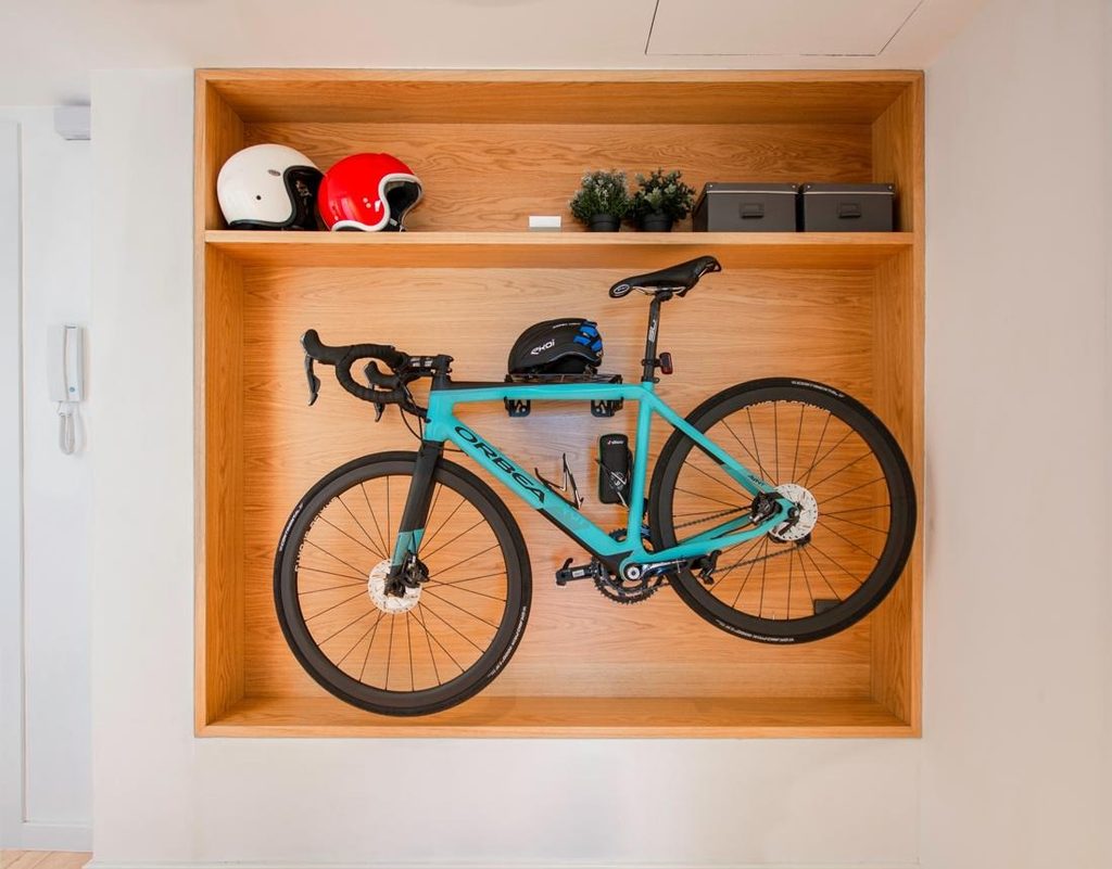 Home bicycle storage setup with a commuter helmet and cycling lights.