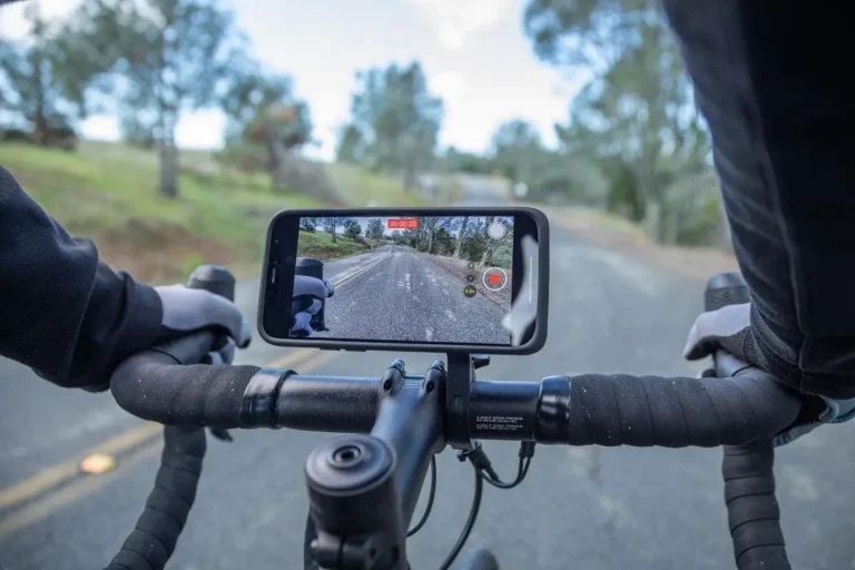 Smartphone securely mounted on bicycle handlebars for recording rides